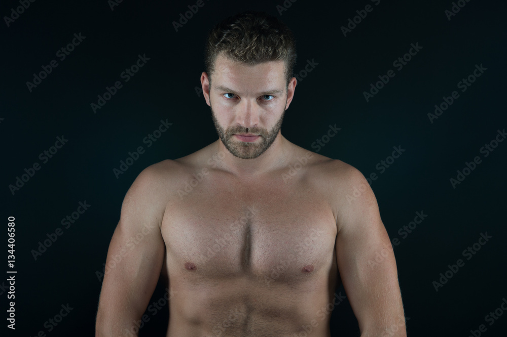 handsome sexy man with muscular body and serious unshaven face