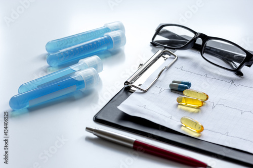 doctors desk with microscope and test tubes