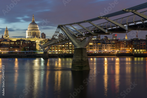 LONDON, ENGLAND - JUNE 18 2016: Night photo of Millennium Bridge, Thames River and St. Paul Cathedral, London, Great Britain