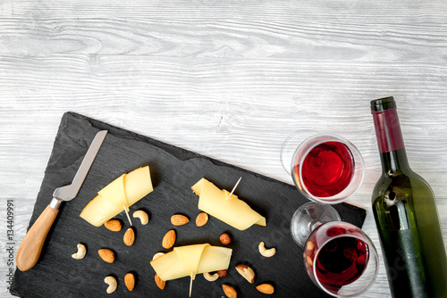 red wine with cheese on wooden background top view