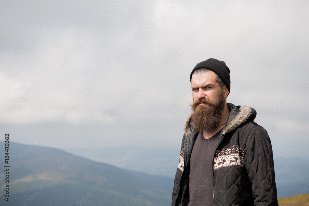 bearded handsome serious man on mountain top