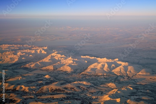 Aerial view of Alaskan mountains covered with snow at sunset north of Fairbanks © eqroy