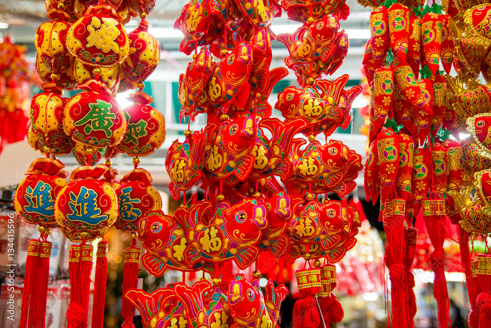 Close-up detail of multiple Chinese ornaments in various shapes on sale during the Chinese New Year. Chinatown, Singapore. Travel and holidays concept.