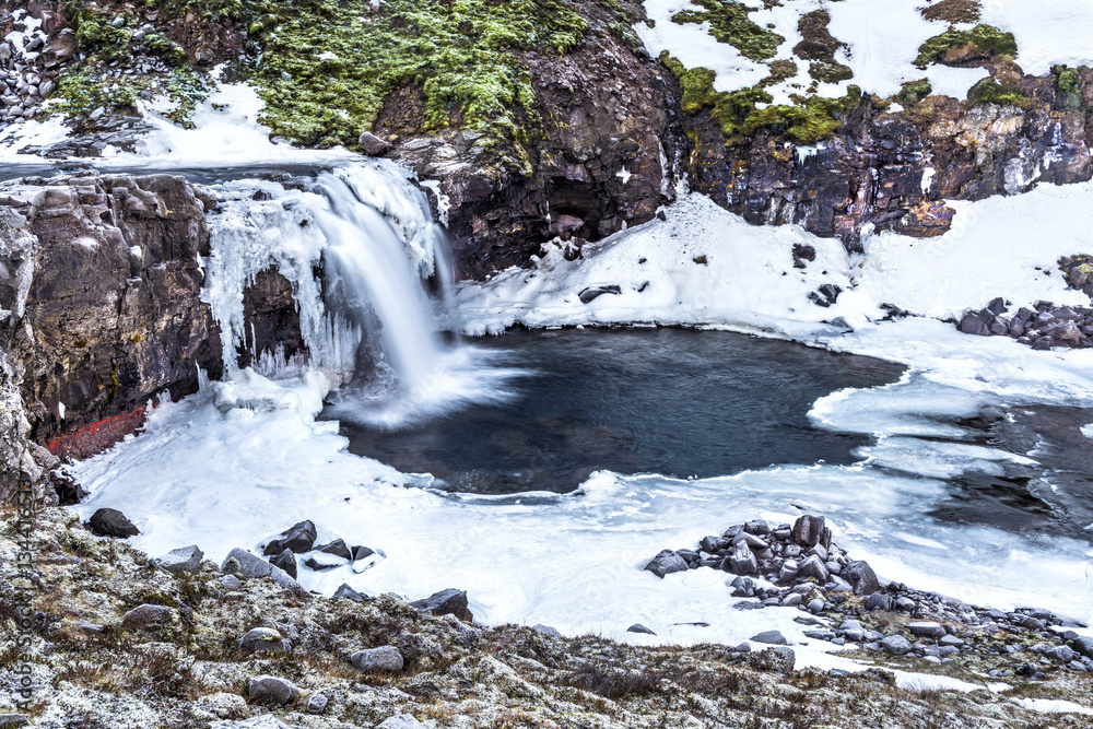 Snowy waterfall in Iceland's highlands Snowy waterfall in Iceland's highlands