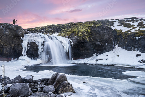 An icy waterfall during sunrise in Iceland