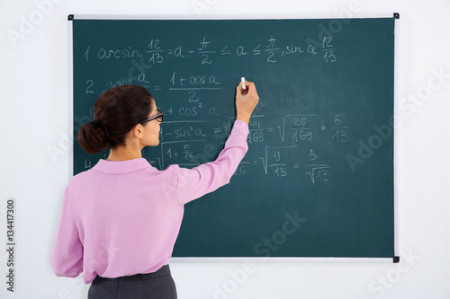 Young female teacher beside...