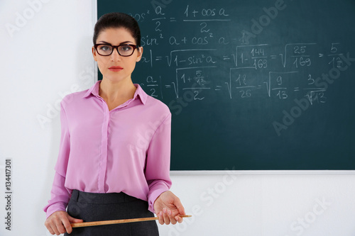 Young female teacher beside...