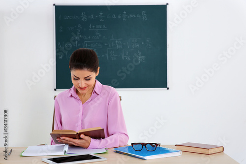 Young beautiful teacher in ...
