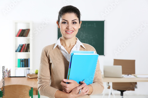 Young beautiful teacher in ...