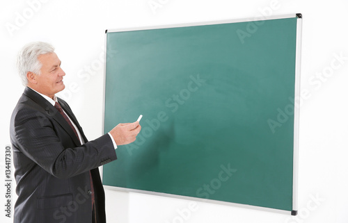 Senior teacher beside black...