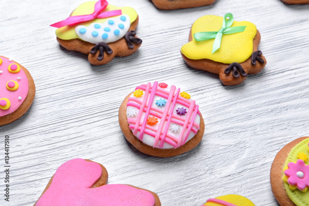 Decorative gingerbread Easter cookies on white wooden background