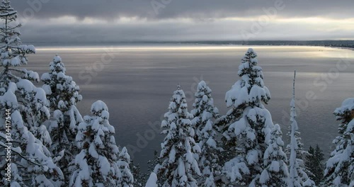 Winter Landscape at Lake Tahoe, California. Footage taken at the tree-lined shoreline near Emerald Bay after a record January snowfall. photo