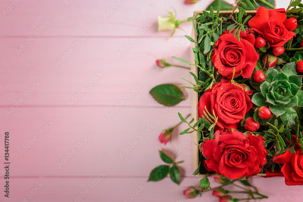Beautiful roses in gift box on wooden background Beautiful roses in gift box on wooden background