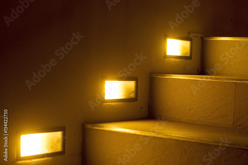 yellow light of stiarcase in home. photo