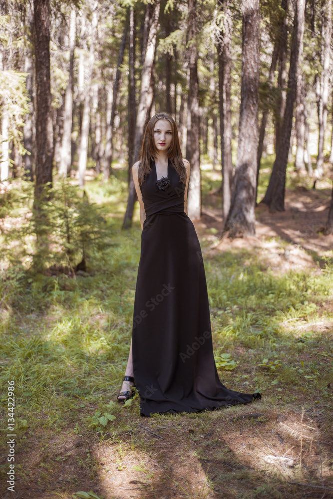 Beautiful young girl walking in a fairy forest. Beautiful young girl walking in a fairy forest.