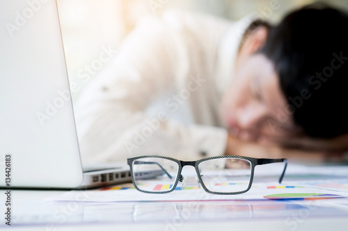  tired businessman sleeping while calculating expenses at desk i