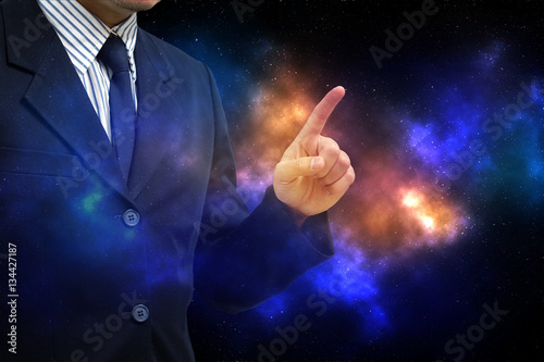 Asian business man finger point up on abstract galaxy background