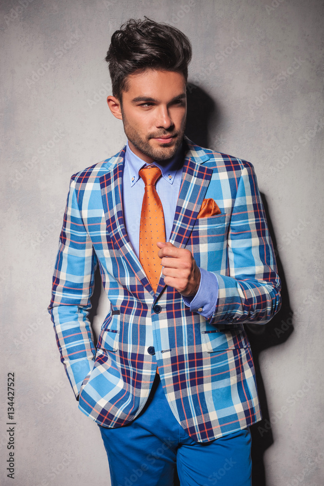 elegant man in checkered suit with hand in pocket elegant man in checkered suit with hand in pocket