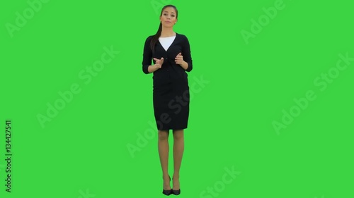 Serious female manager talking to camera ticking off on her fingers on a Green Screen, Chroma Key