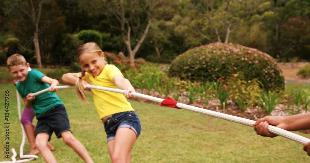 Kids playing tug of war in park on a sunny day 4k Kids playing tug of war in park on a sunny day 4k