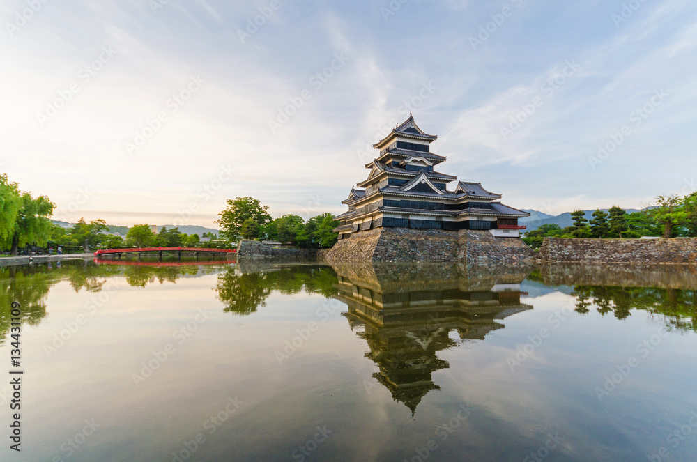 Matsumoto castle reflect on water in evening at nagano japan