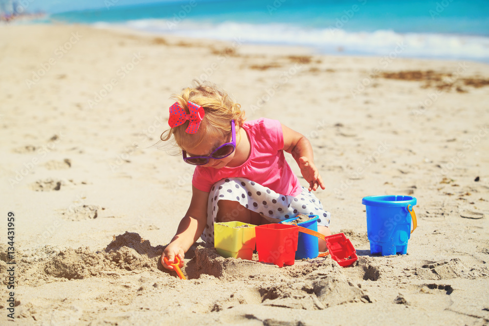 cute little girl play with sand on beach cute little girl play with sand on beach