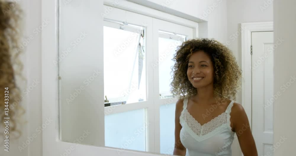 Reflection of smiling woman looking in bathroom mirror at home 4k Reflection of smiling woman looking in bathroom mirror at home 4k