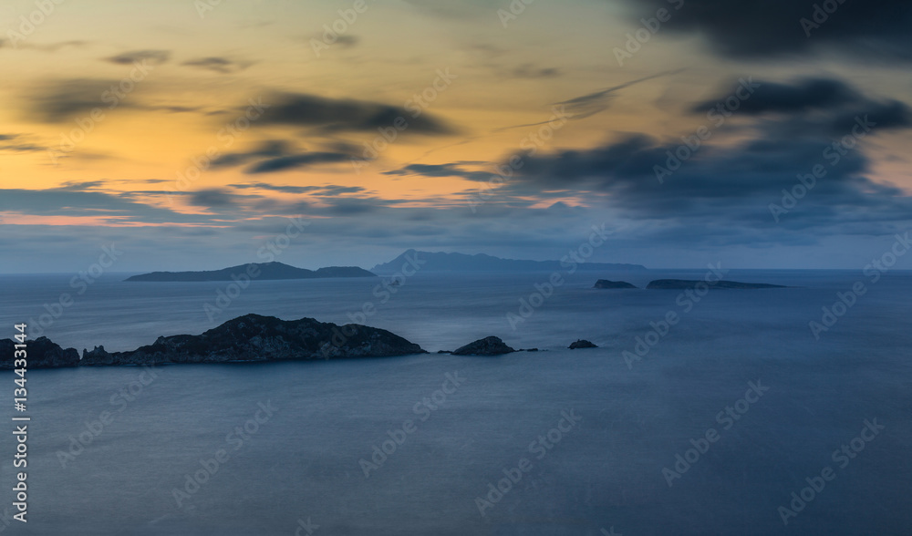 Long exposure Panoramic Seascape at dusk. View of the cliff into the sea and distant islands. Agios Stefanos cape. Afionas. Corfu. Greece.