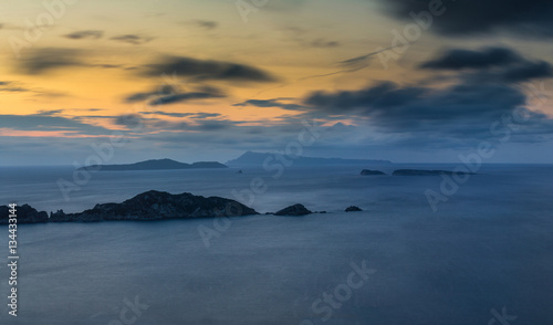 Long exposure Panoramic Seascape at dusk. View of the cliff into the sea and distant islands. Agios Stefanos cape. Afionas. Corfu. Greece.