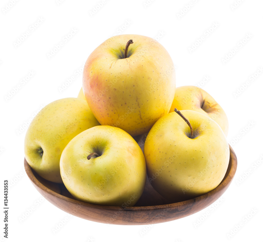 big ripe juicy yellow golden apples in wooden bowl isolated on white background big ripe juicy yellow golden apples in wooden bowl isolated on white background