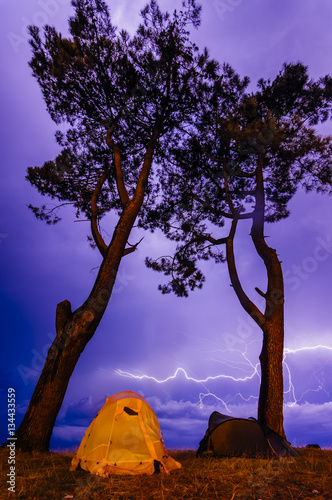 Two tents under the tree in the night. Camping in thunderstorm. Kobuleti, Georgia photo