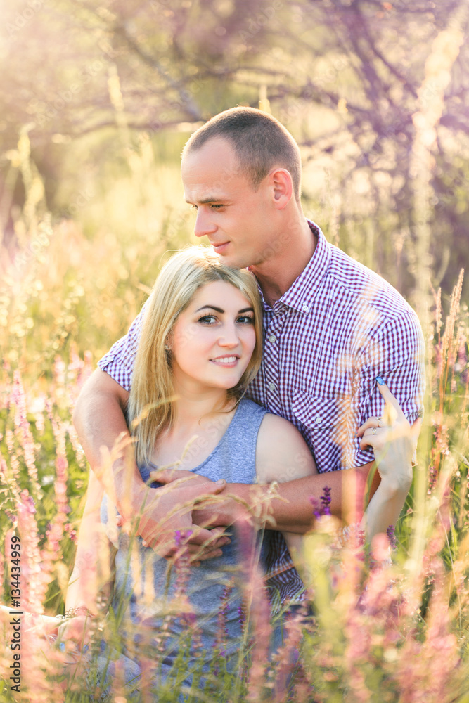 Fototapeta premium Attractive man and woman sitting on nature.