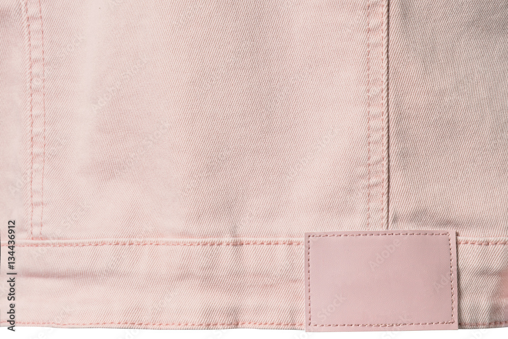 Pale pink denim with leather label for background Pale pink denim with leather label for background