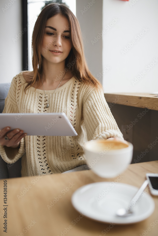 Occupied woman taking cup of cappuccino in cafe Occupied woman taking cup of cappuccino in cafe