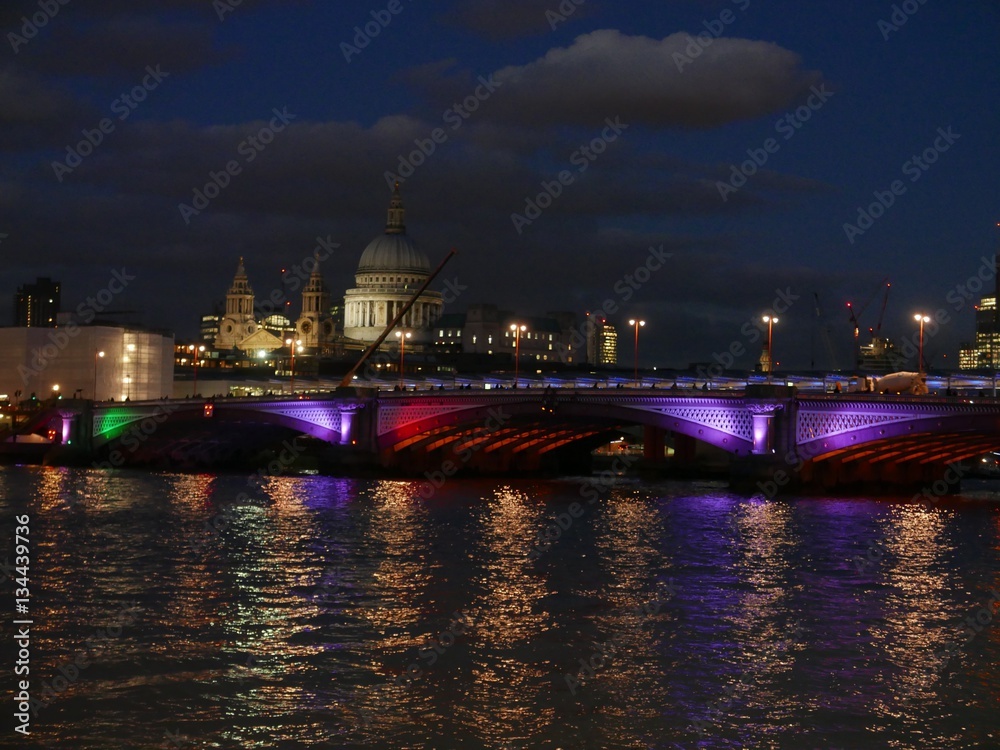 London cityscape of BlackFriars Bridge at night with St. Paul's cathedral in the background 