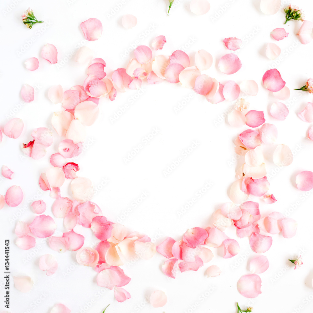 Frame made of pink roses petals on white background. Flat lay, top view. Valentine's background