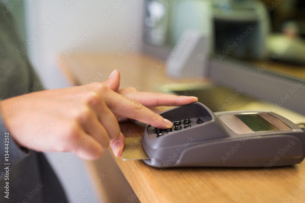 close up of hand entering code to money terminal close up of hand entering code to money terminal