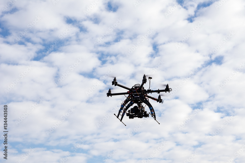 Drone flying on the sky background Drone flying on the sky background