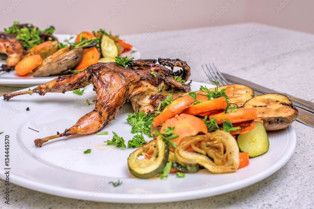 Roasted homemade quail with vegetables. Healthy food. Perfect dinner for two