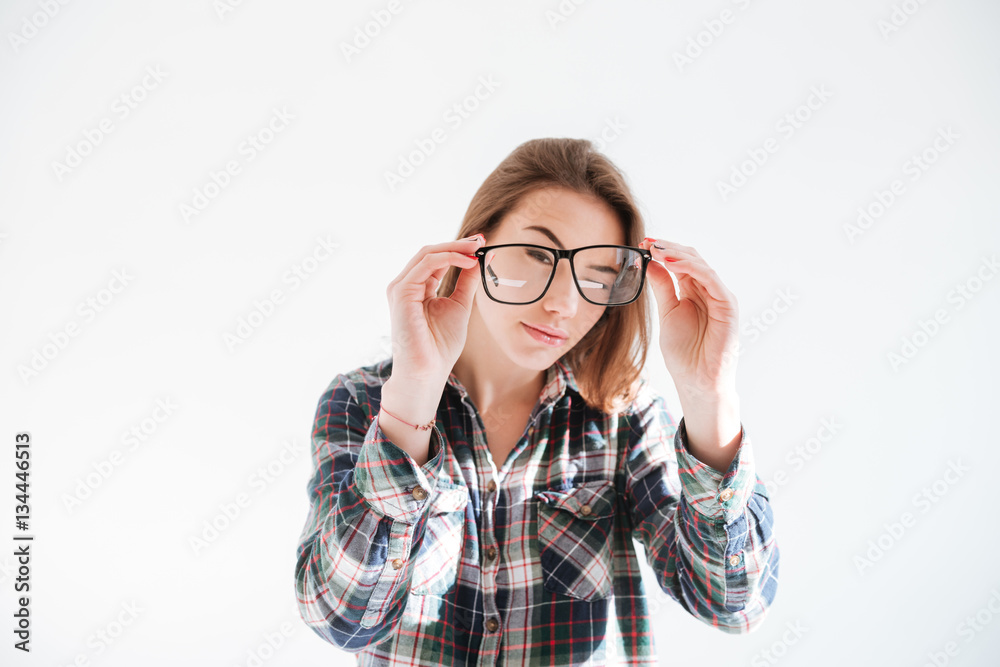 Concentrated woman holding glasses and posing Concentrated woman holding glasses and posing