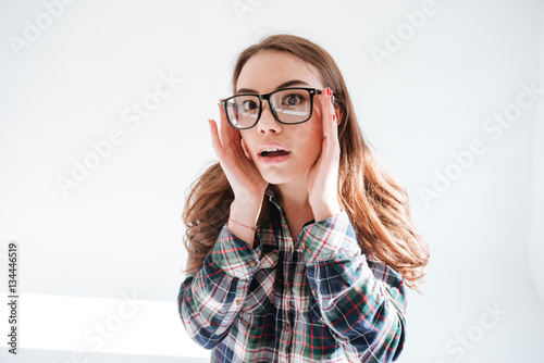 Shocked woman wearing glasses look at camera