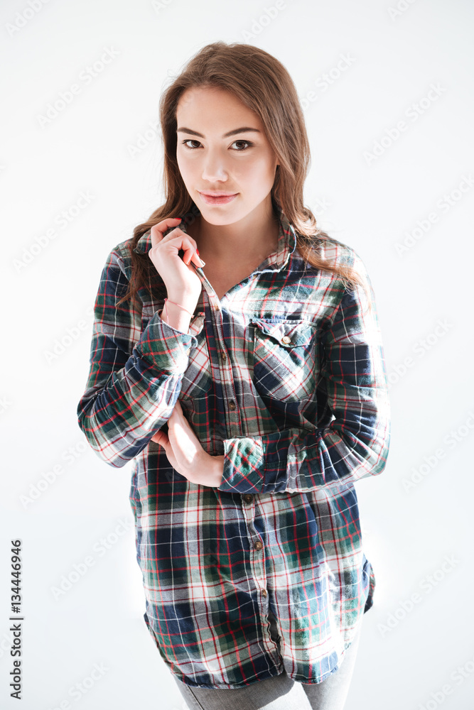 Beautiful young woman in plaid shirt standing and posing Beautiful young woman in plaid shirt standing and posing