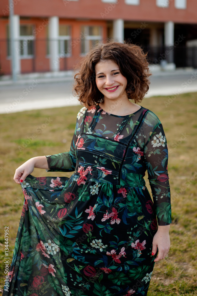 Happy curvy girl with curly hair in the street Happy curvy girl with curly hair in the street