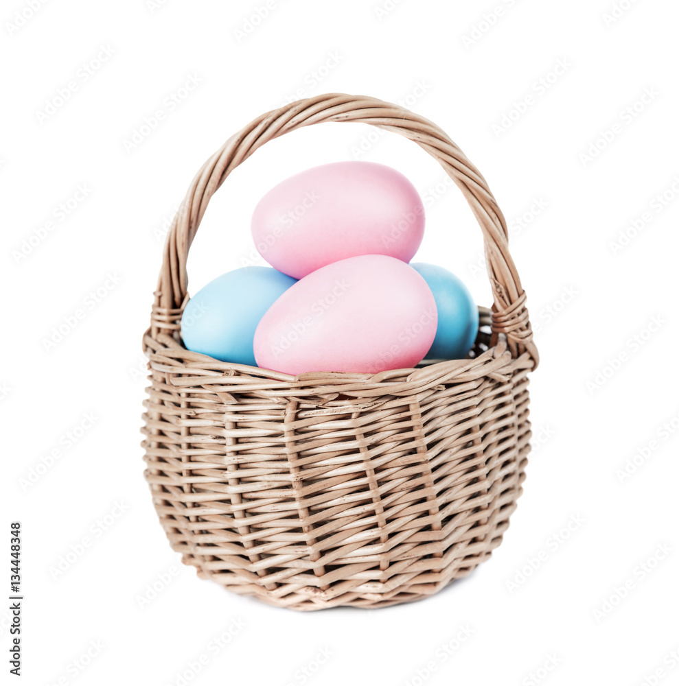 Basket with Easter eggs on white background
