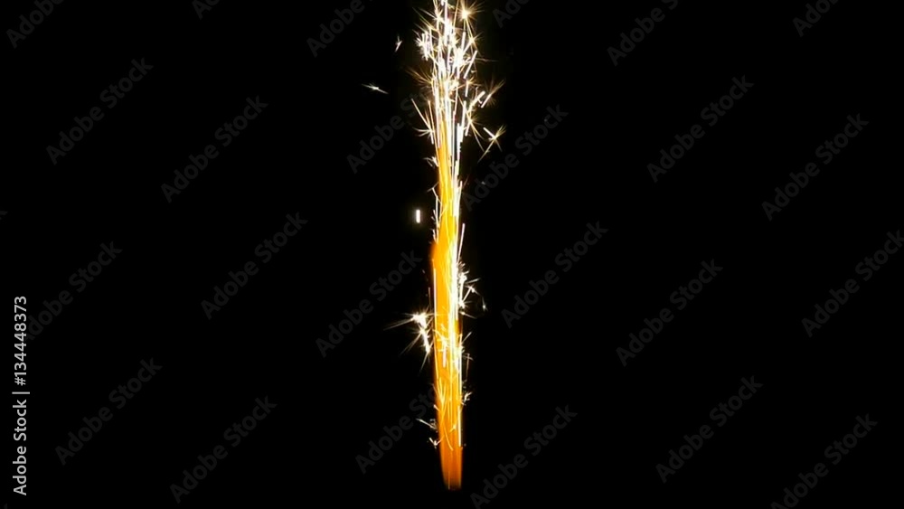 Jet of glitter and sparkles isolated on a black background in slow motion