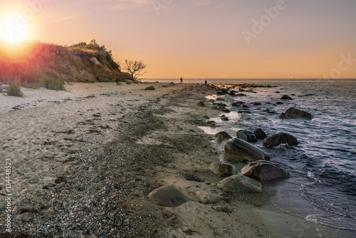 natural beach at baltic sea coast on the island of Fehmarn, Germany during sunset photo