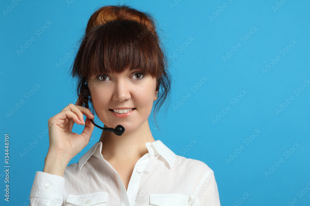 Portrait of a young smiling woman with headset working in a call center. Portrait of a young smiling woman with headset working in a call center.
