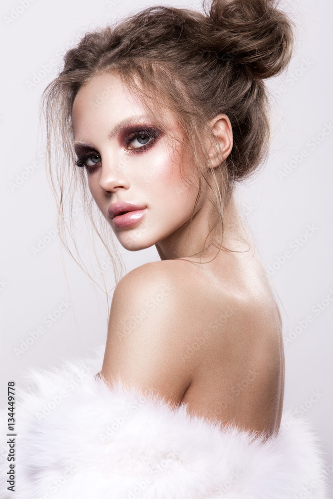 Beautifful european brunet woomen with gloss clean healfy skin, glooss shiny pastel pink lipstik and with trendy fashion hairstyle in white fluffy fur coat Beautifful european brunet woomen with gloss clean healfy skin, glooss shiny pastel pink lipstik and with trendy fashion hairstyle in white fluffy fur coat