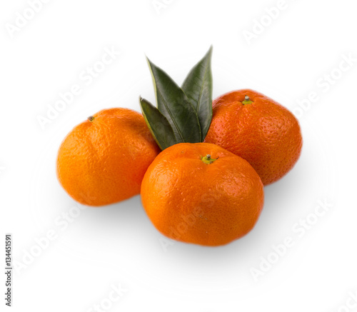  Ripe mandarin with leaves close-up on a white background