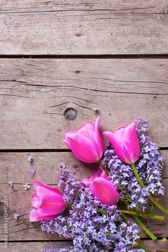 Fototapeta Naklejka Na Ścianę i Meble -  Background with  lilac  and pink tulips flowers on vintage woode